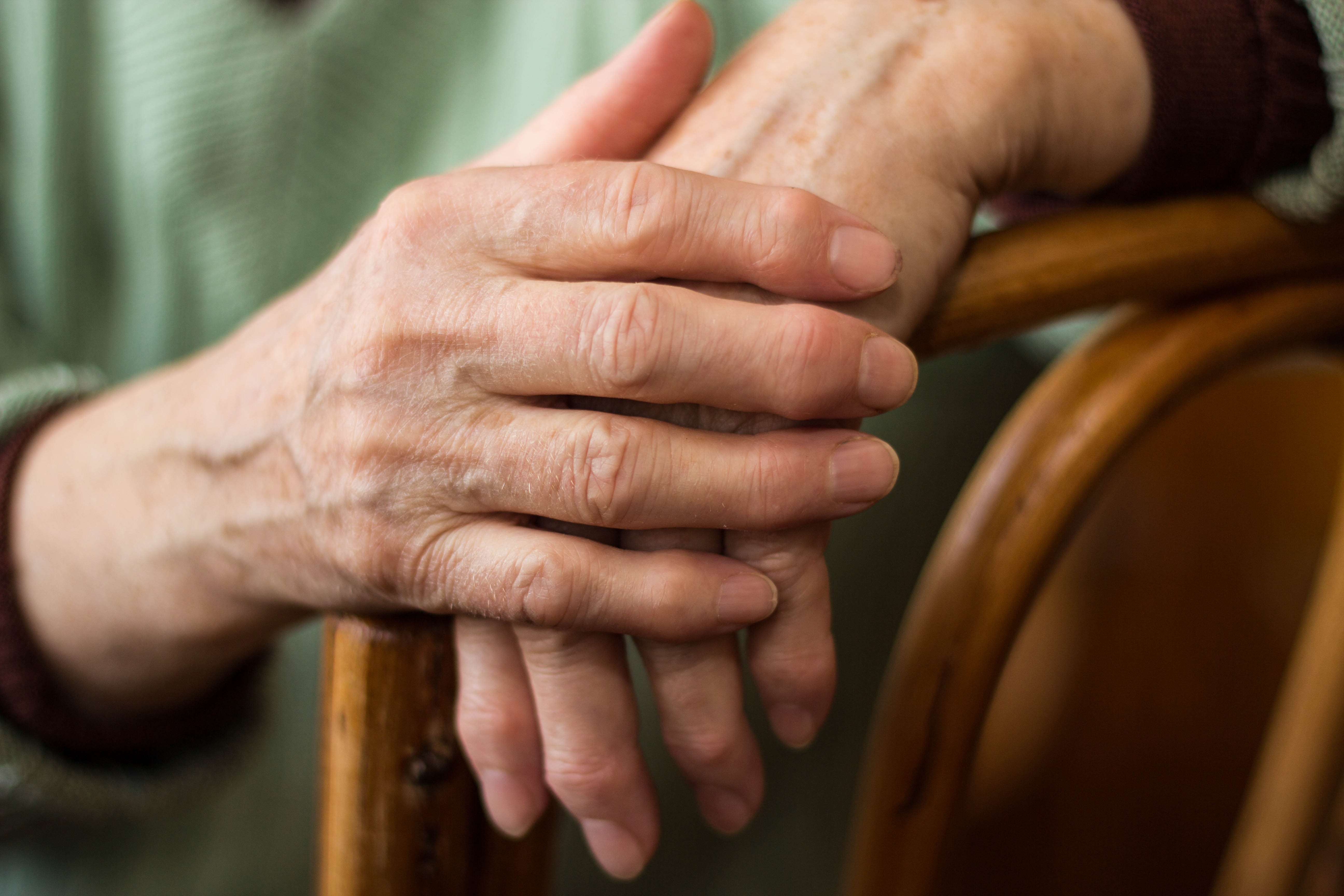 Shutterstock: hands resting on armrest.