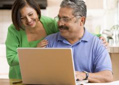 man and woman working on laptop