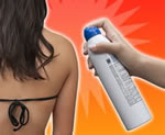 Sunscreen being sprayed on a woman